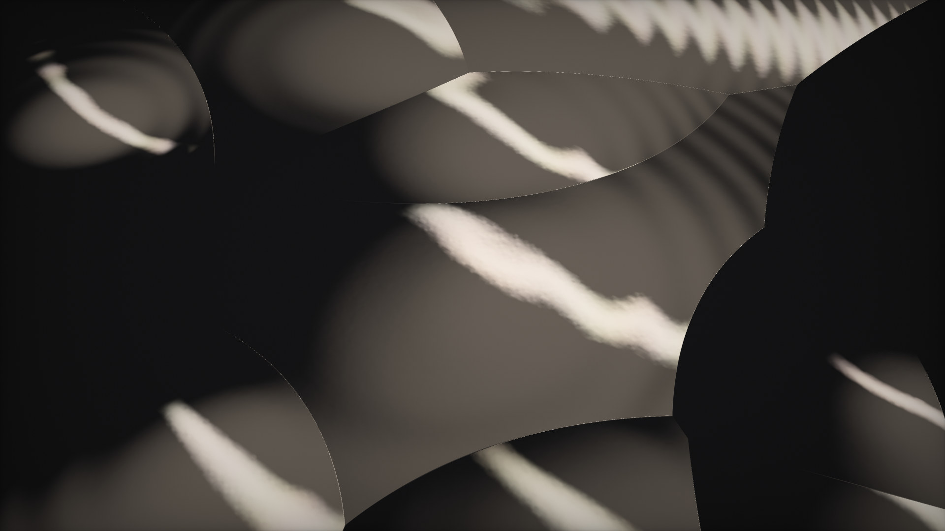 Macro view of knapped obsidian: overlapping glassy scoops with a soft band of light across them.