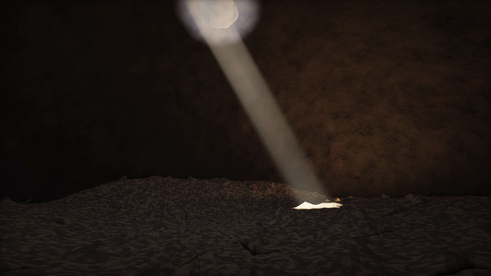 A dark volcanic cave pierced by a single beam of sunlight that lands on a mound of pale sand.